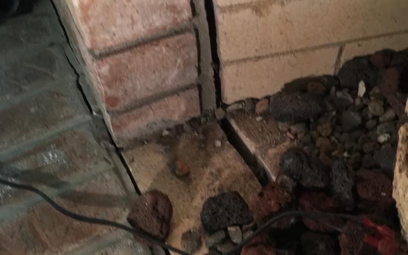 Crack caused by movement in the home&#039;s foundation creating a fire hazard
